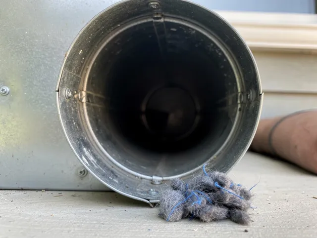Vernon Dryer Vent Cleaning technician using specialized equipment to clear severe dryer vent blockage in Vernon